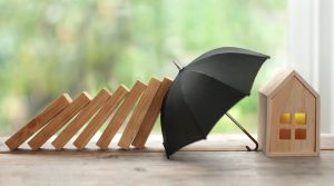 umbrella covering a miniature business figurine